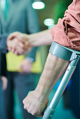 Injured worker shaking hands - workers' comp claims management.