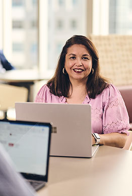Business woman at computer evaluating a businessowners policy.